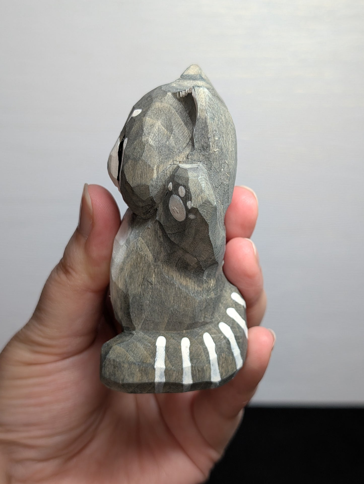 Hand painted wooden raccoon carvings