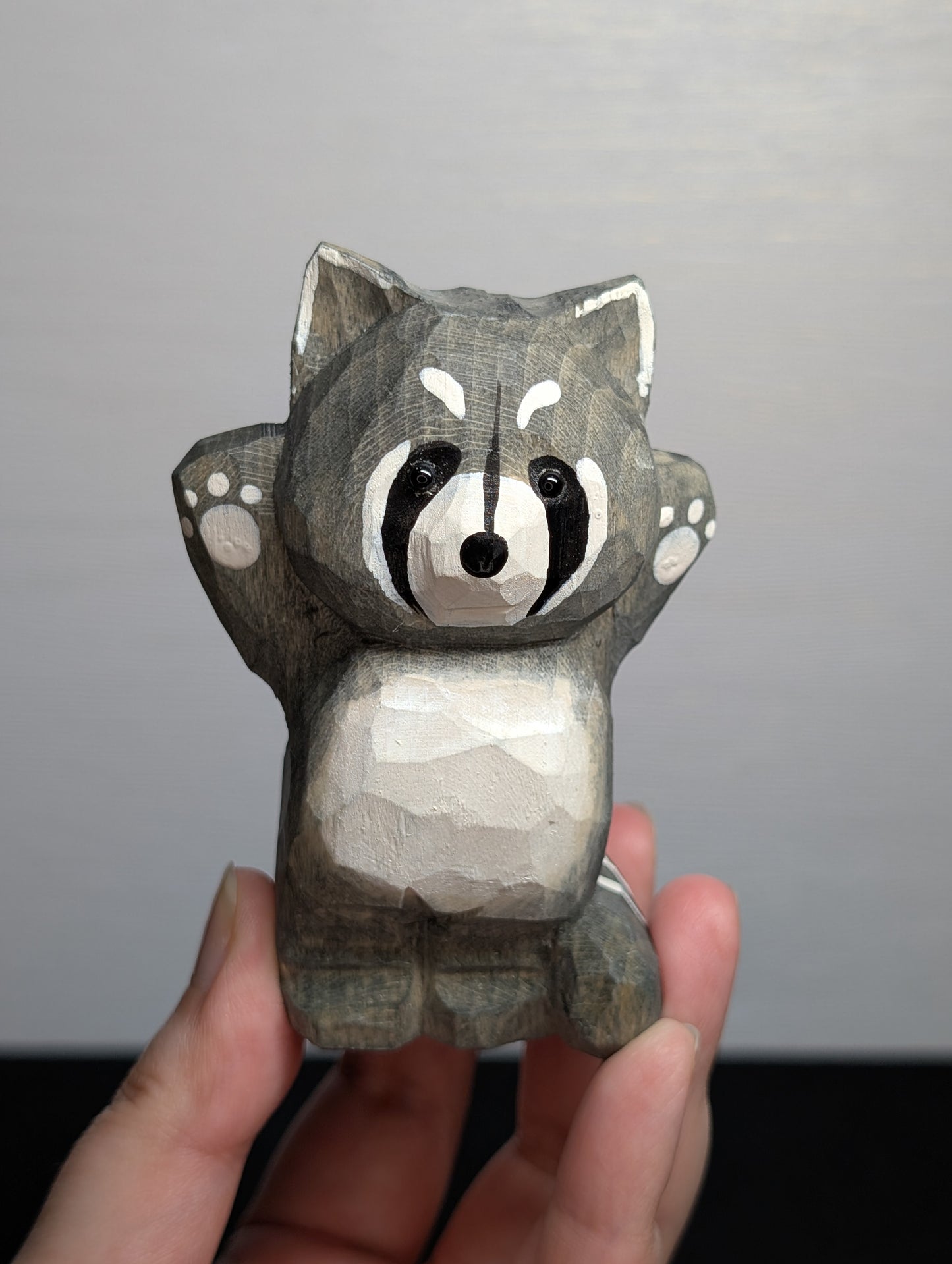 Hand painted wooden raccoon carvings